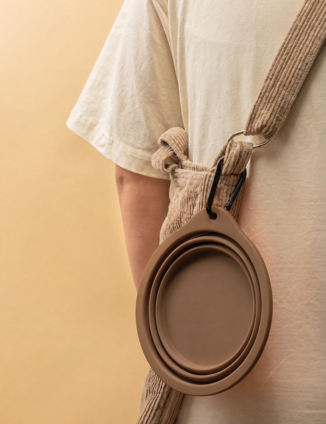 Portable brown collapsible silicone pet bowl for dogs and cats with carabiner clip