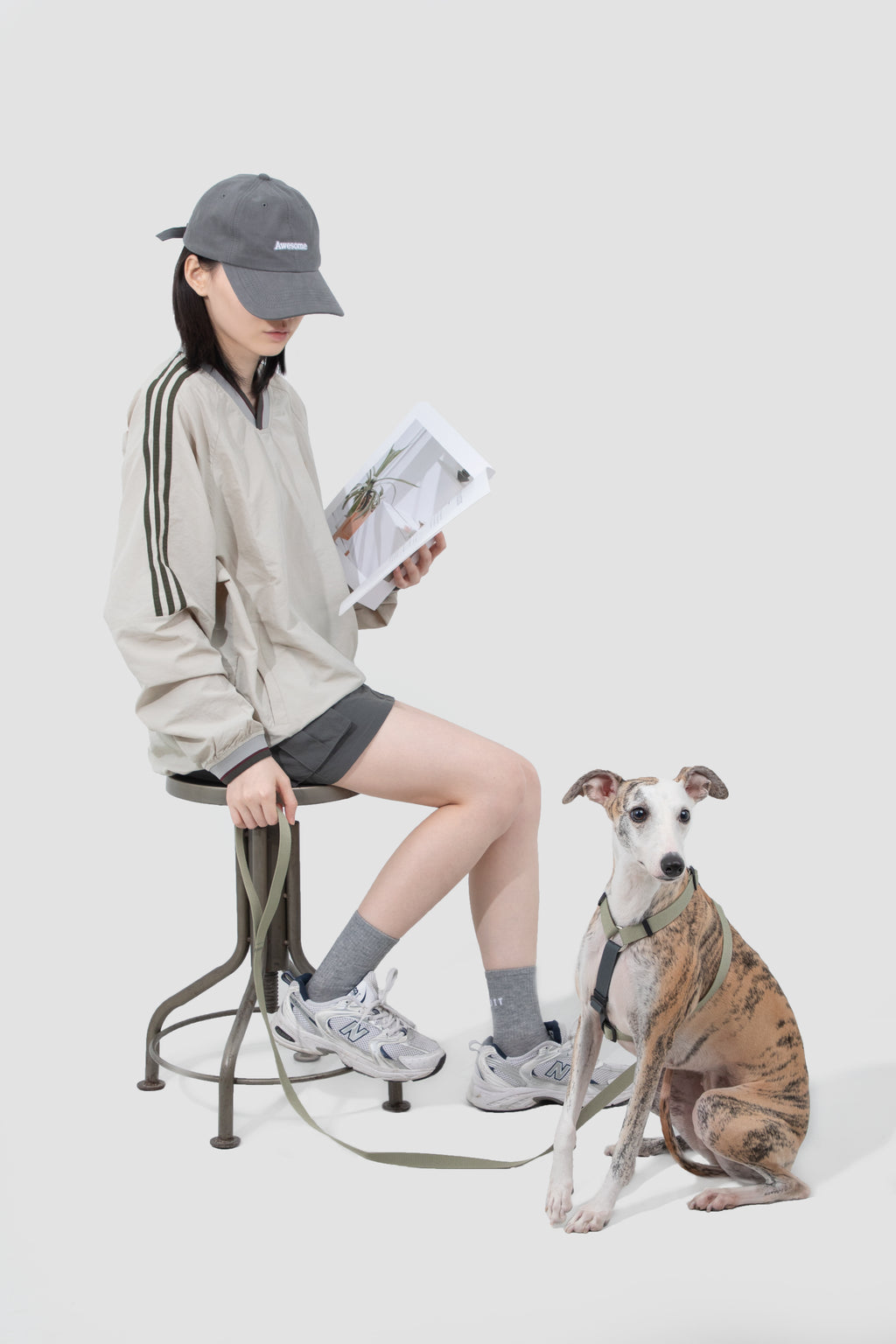 Owner and dog wearing an adjustable H-style harness outdoors
