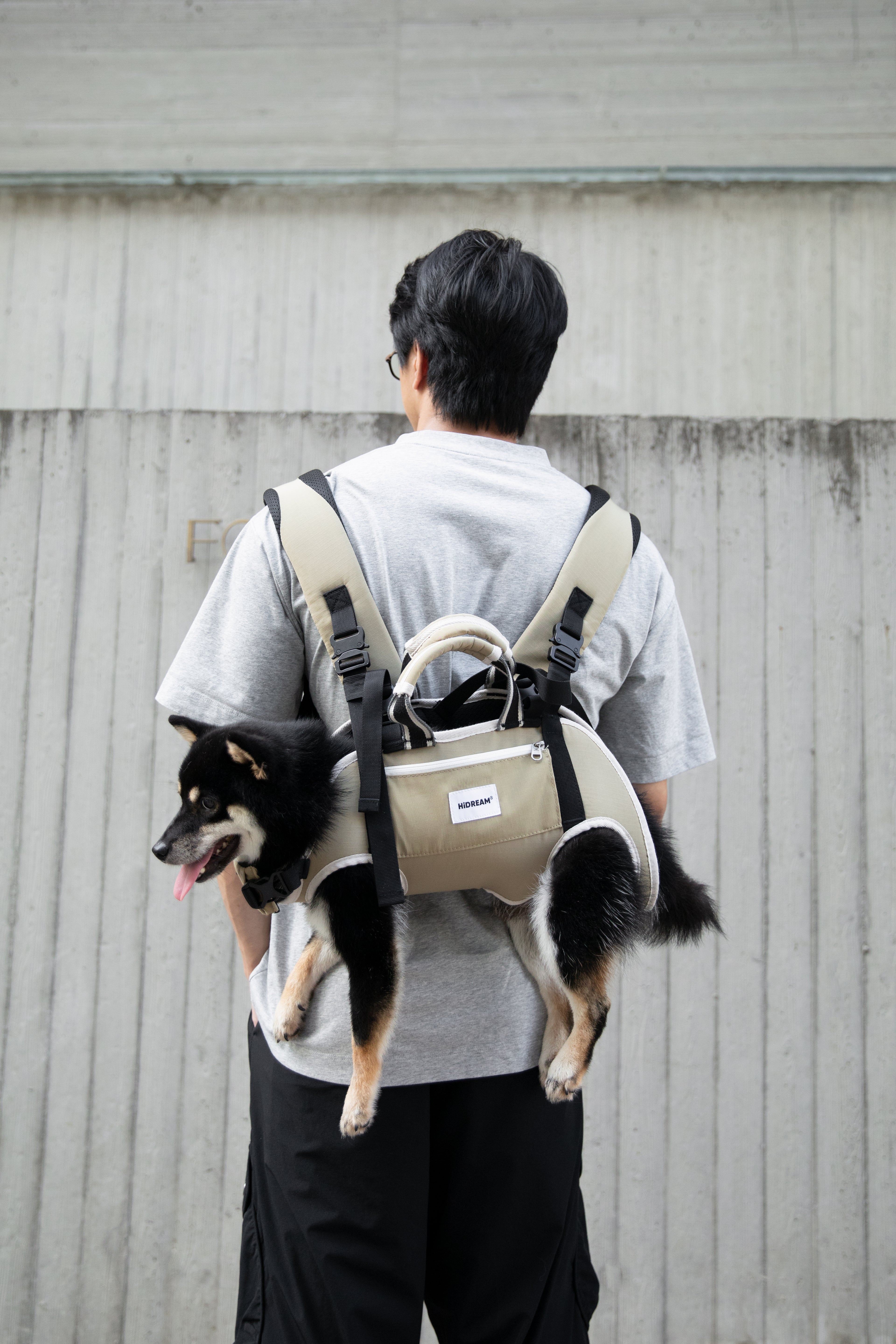 Person wearing an ergonomic pet backpack carrier outdoors