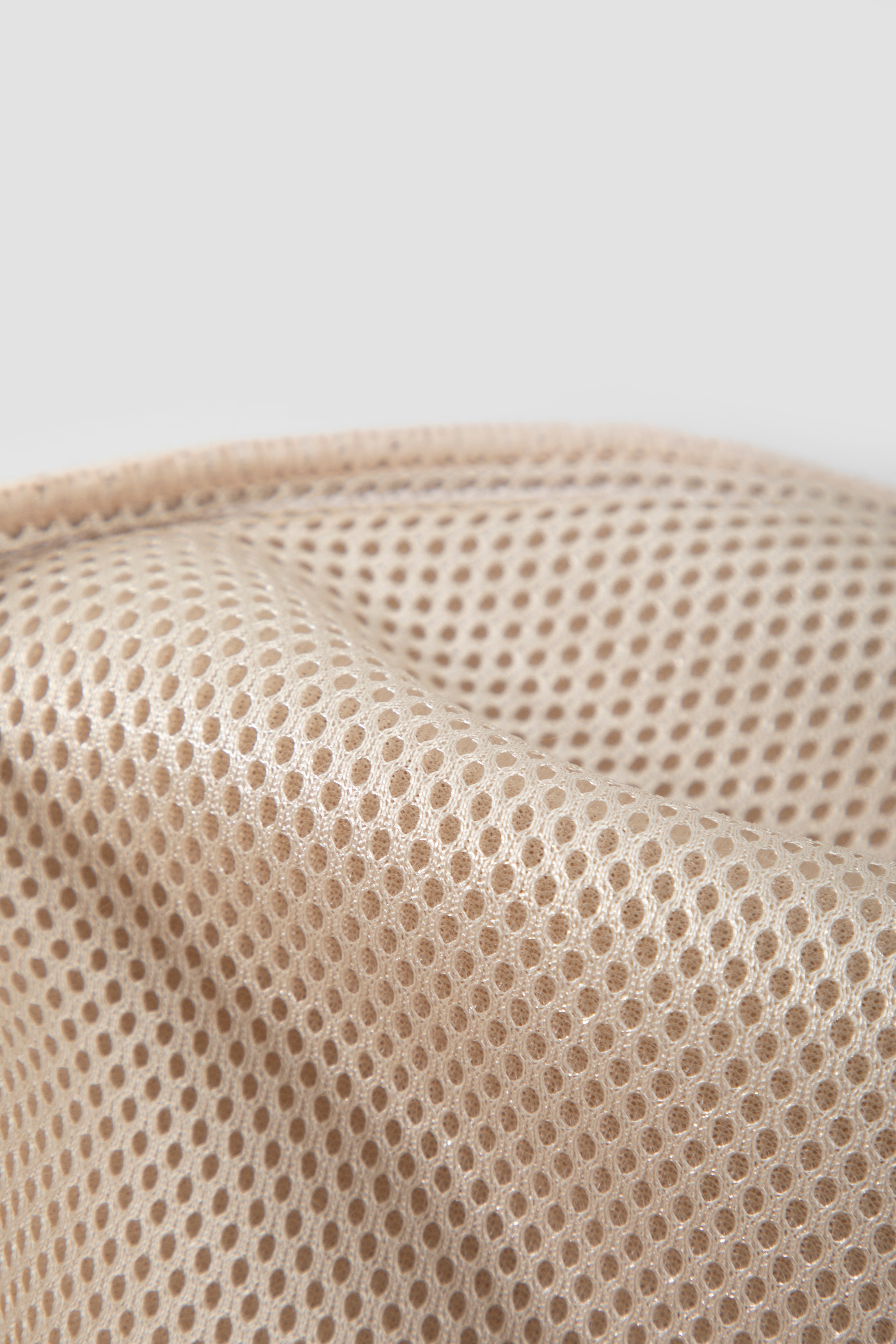 Breathable mesh fabric detail on a pet sling carrier